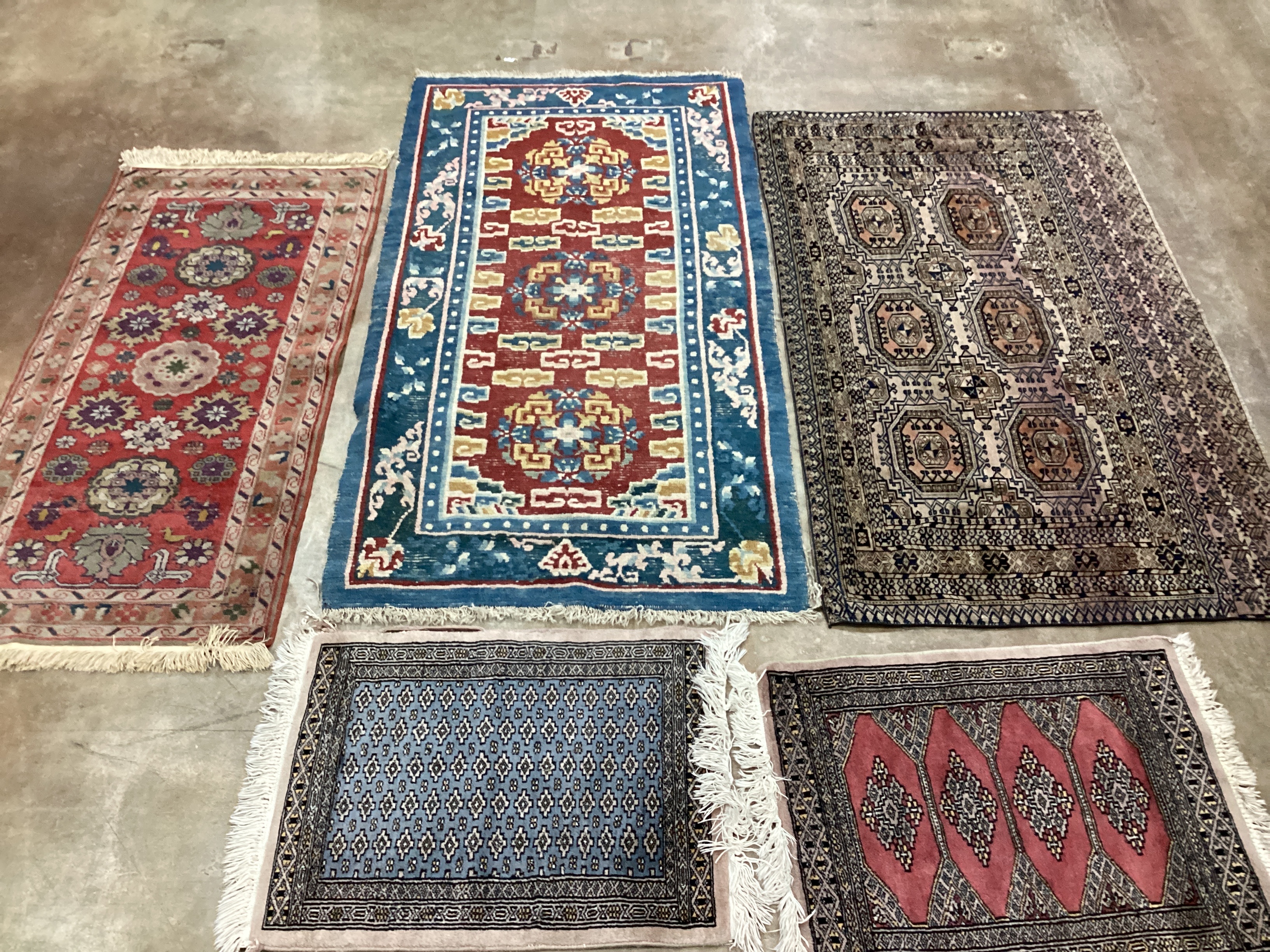 A Tekke mat, two Bokhara mats and two rugs, (5), largest 132 x 78cm